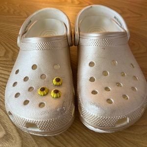 Metallic gold Crocs with sunflower jibbitz